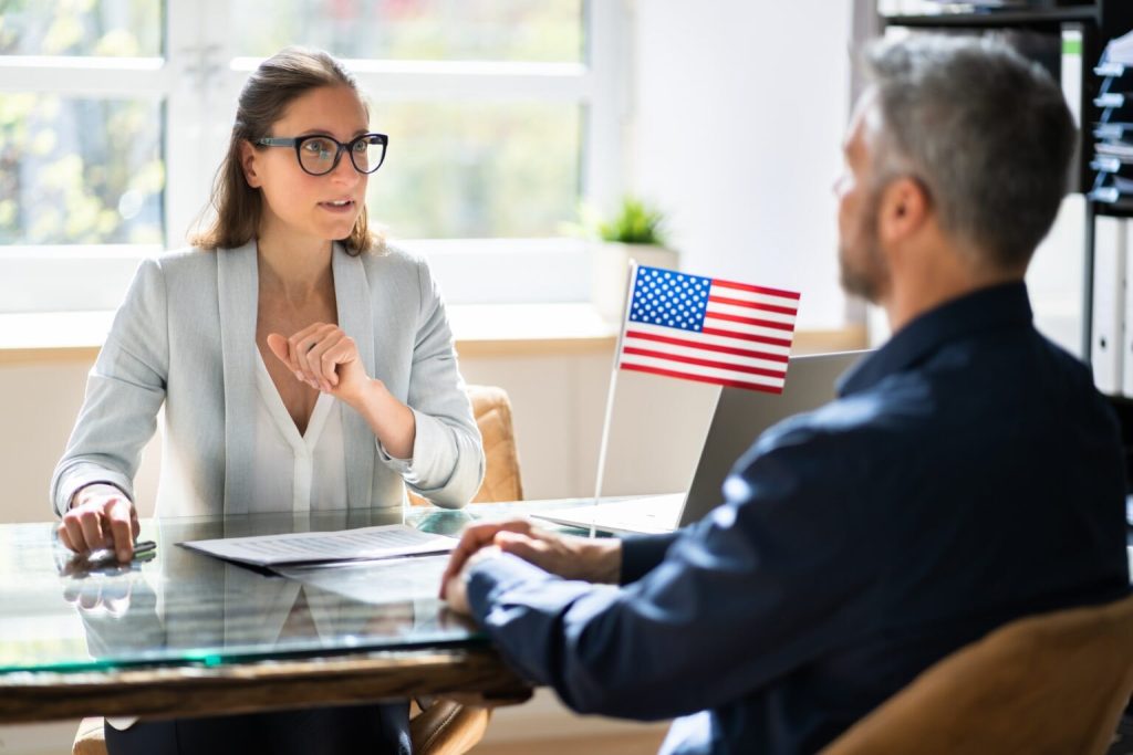 Immigration lawyer and client discussing whether or not USCIS May Deny Cases Without an RFE