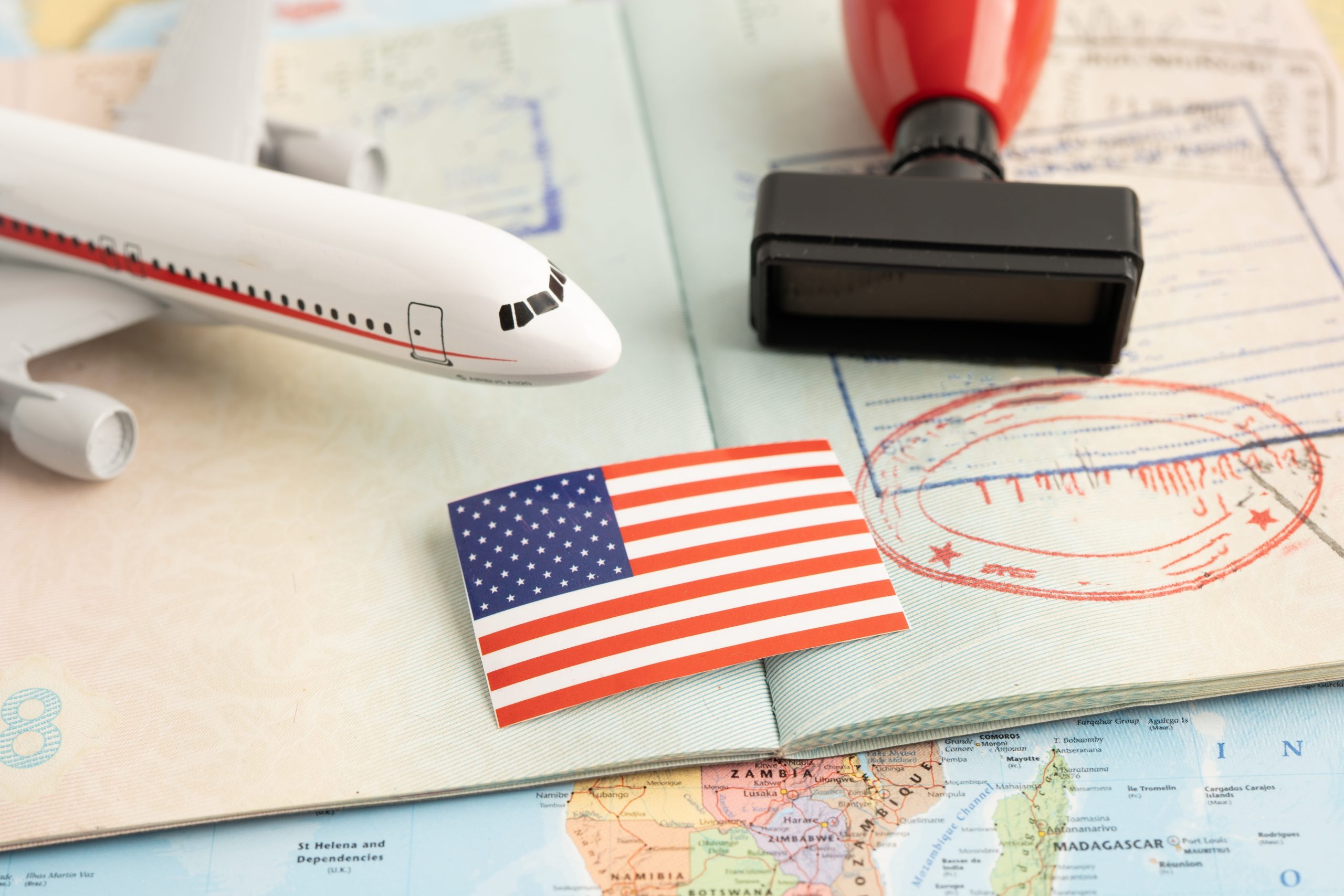 An aeroplane, Us flag & an approved travel visa.