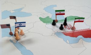 Map of Iran, Israel, and the United States with flags and chess pieces representing geopolitical conflict and its impact on immigration and global policy