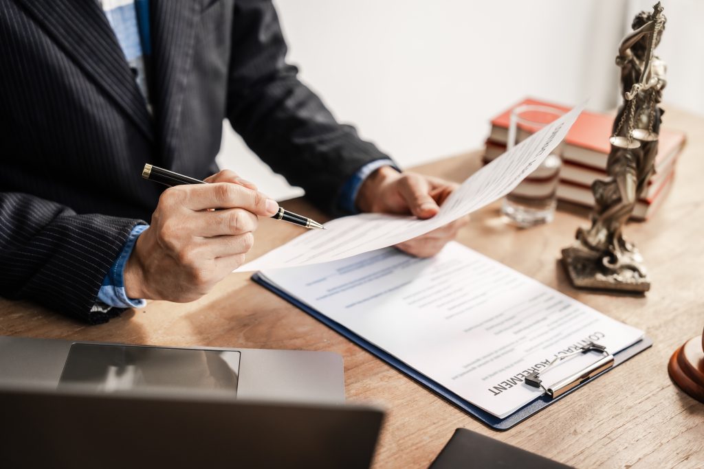 Immigration lawyer in Houston carefully reading documents to ensure there are no mistakes.