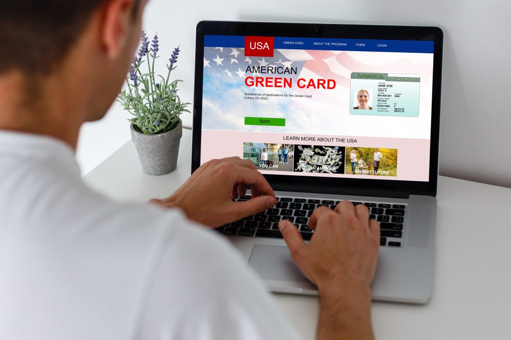 man with laptop with United States Permanent Resident Card website
