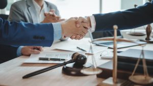 Shaking hands, Immigration lawyer houston team. Working together judge counselor having team meeting with client discussing legal legislation at law firm, Law and Legal services concept.