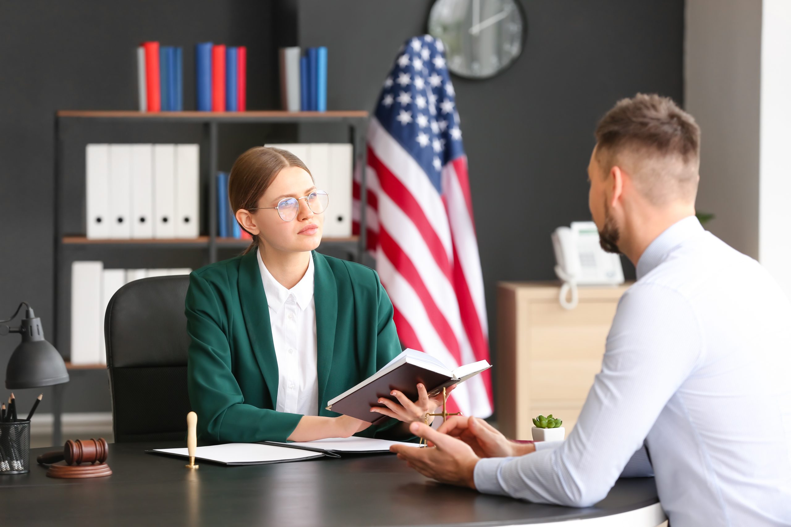 Client with attorney discussing whether Adjustment of Status or Consular Processing is the right option for him.