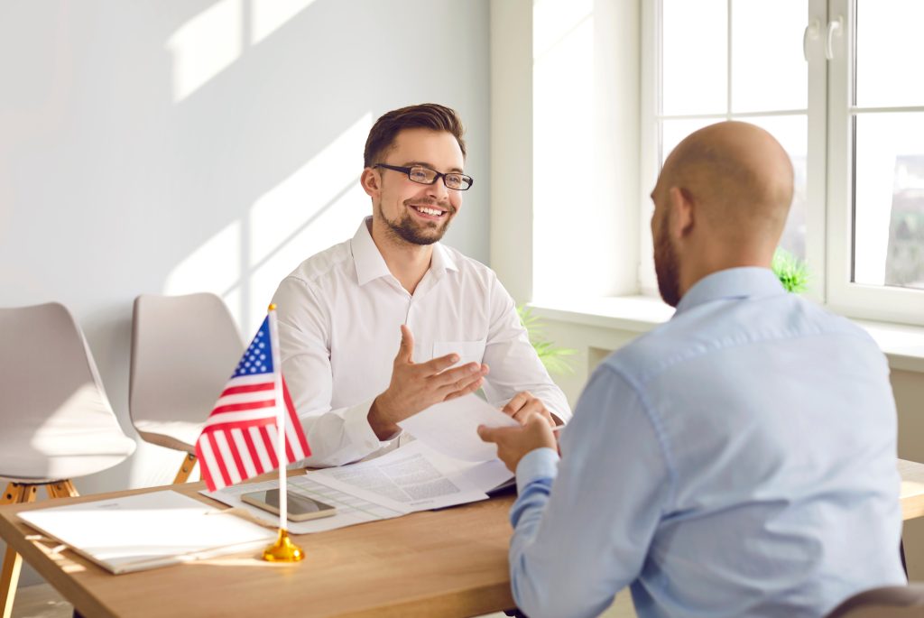 Client with attorney discussing whether Adjustment of Status or Consular Processing is the right option for him.