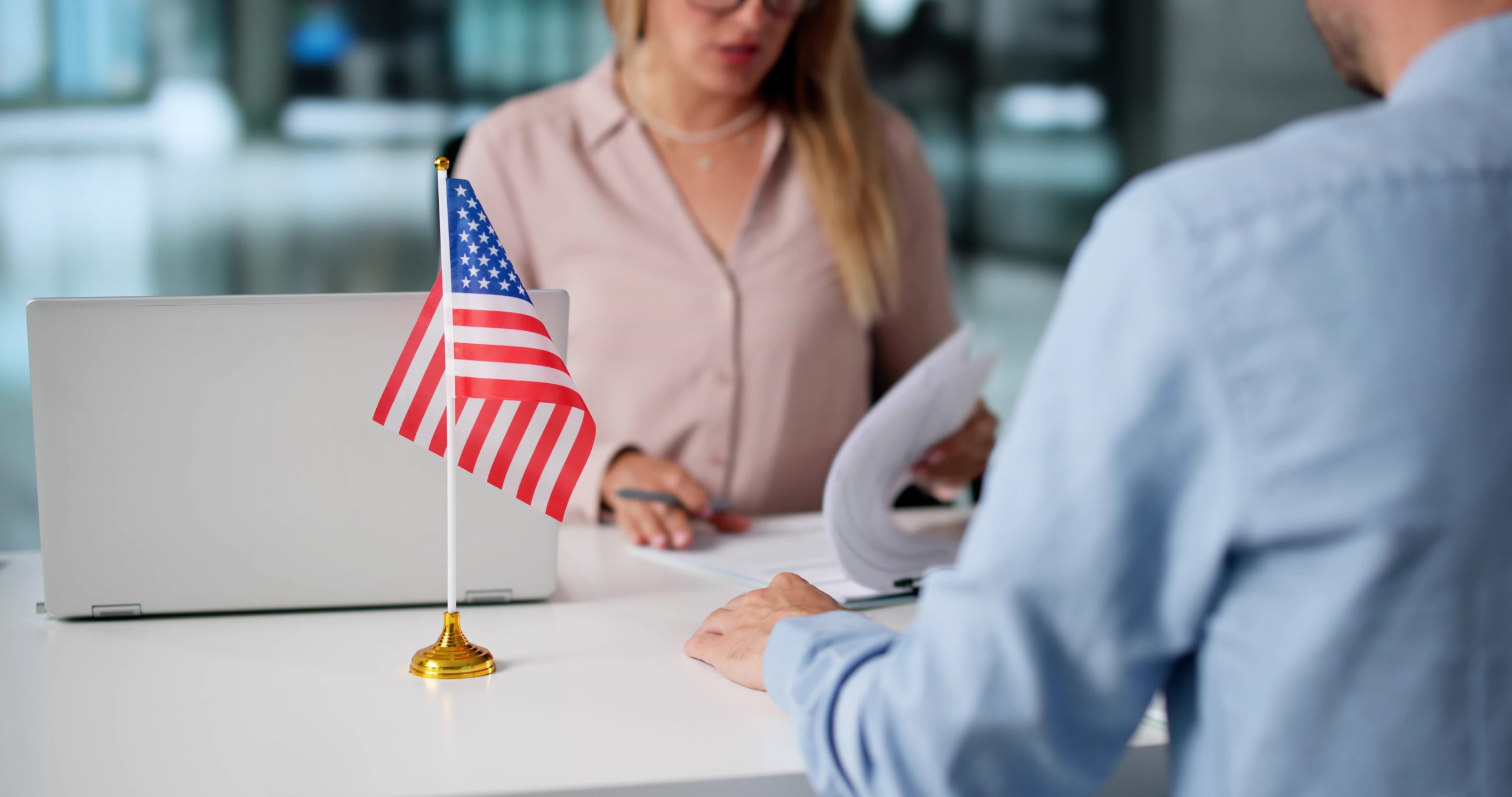 Immigration Lawyer Assisting Clients at Abbasi Immigration Law Firm. The man wants to aplly for green card and is worried about the public charge rule on 18th september so he is talking to attorney.
